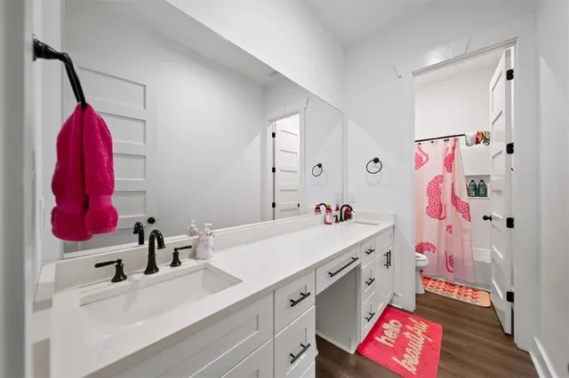 a bathroom with a sink a toilet and a mirror