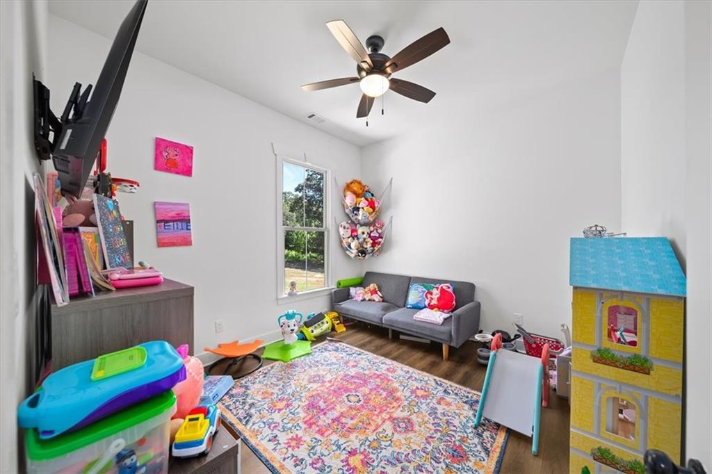 1380 Cronic Town Road Auburn, GA 30011 - Photo 32 of 69 a play room with toys and a wooden floor