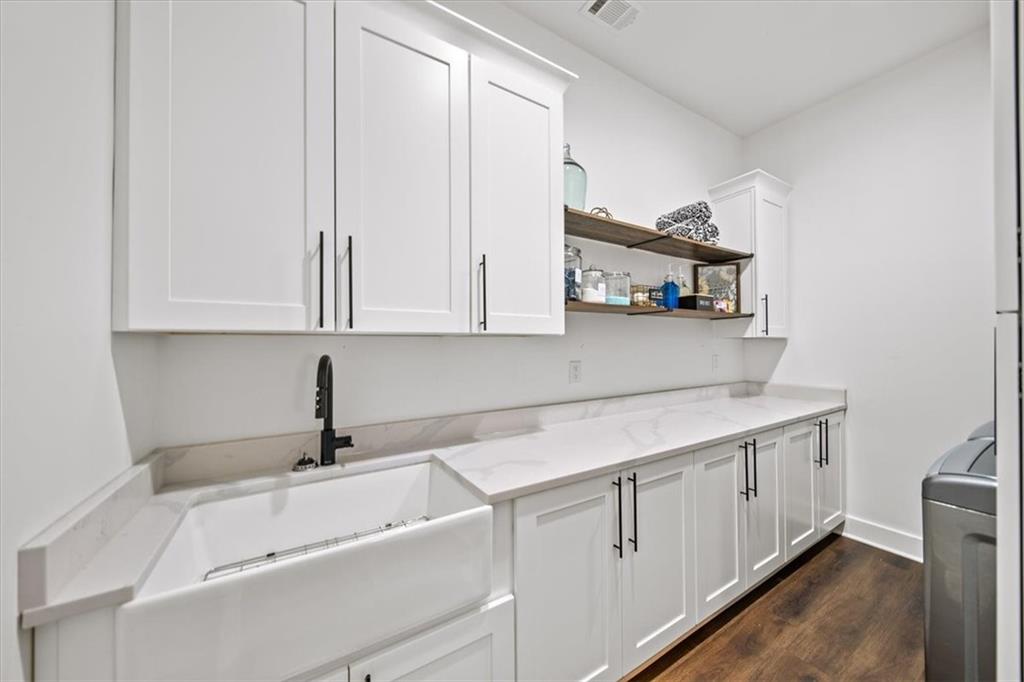 1380 Cronic Town Road Auburn, GA 30011 - Photo 33 of 69 a kitchen with white cabinets and sink