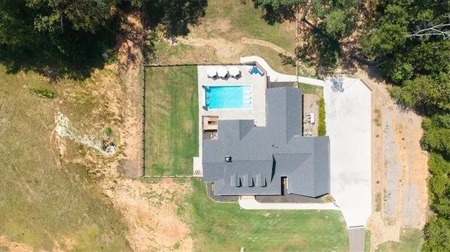 a kitchen with stainless steel appliances granite countertop a stove a sink dishwasher and a refrigerator with wooden floor