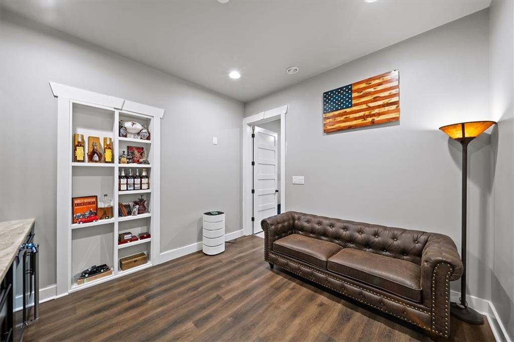 1380 Cronic Town Road Auburn, GA 30011 - Photo 42 of 69 a living room with furniture and a book shelf