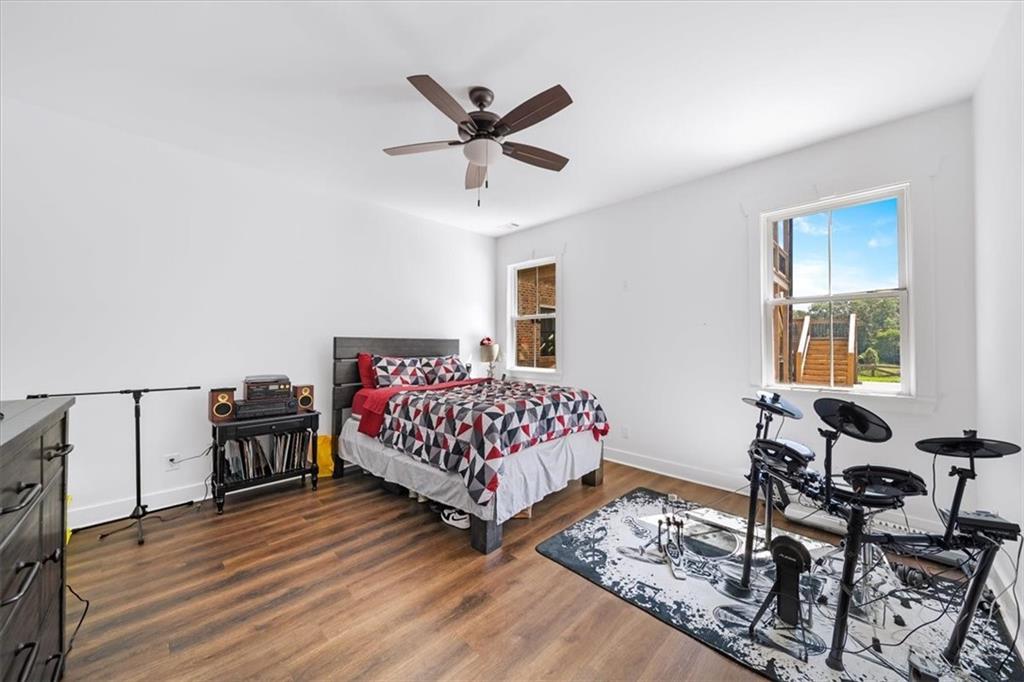 1380 Cronic Town Road Auburn, GA 30011 - Photo 45 of 69 a bedroom with a bed and wooden floor