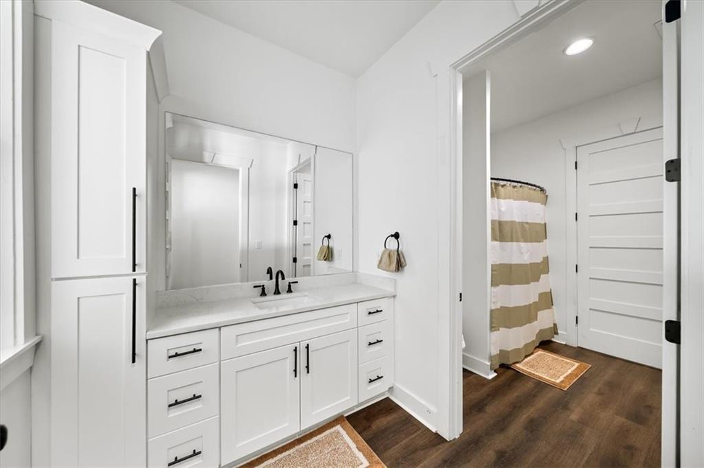 1380 Cronic Town Road Auburn, GA 30011 - Photo 46 of 69 a bathroom with a double vanity sink and mirror