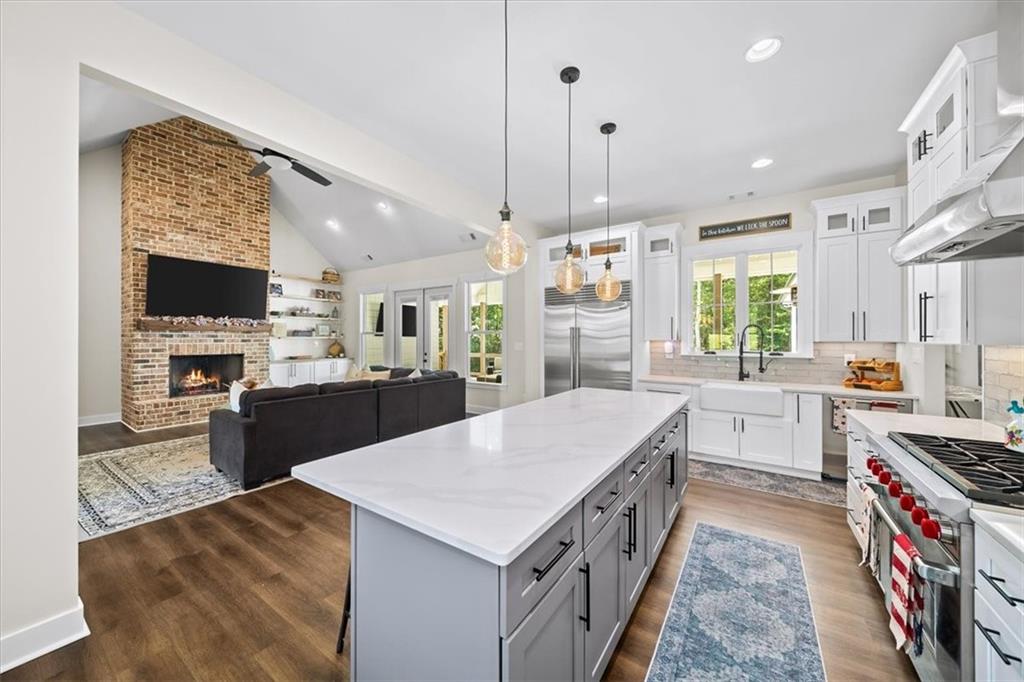 1380 Cronic Town Road Auburn, GA 30011 - Photo 7 of 69 a large kitchen with stainless steel appliances granite countertop a lot of counter space and wooden floors