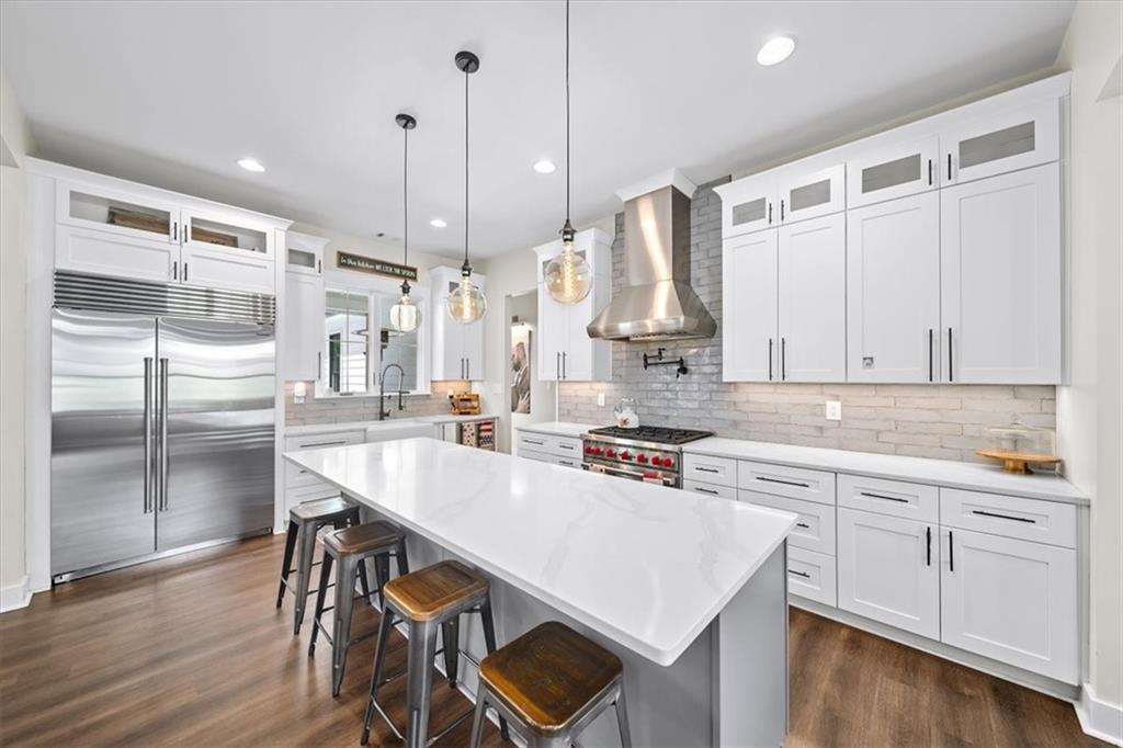 1380 Cronic Town Road Auburn, GA 30011 - Photo 8 of 69 a kitchen with stainless steel appliances granite countertop a stove a sink dishwasher and a refrigerator with wooden floor