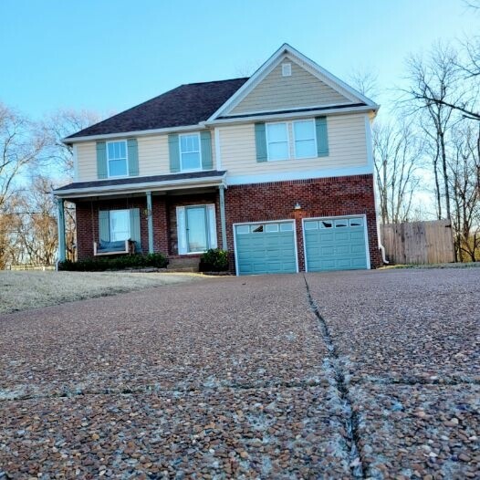 1457 Bern Drive Spring Hill, TN 37174 - Photo 2 of 28 a front view of a house with a yard and garage