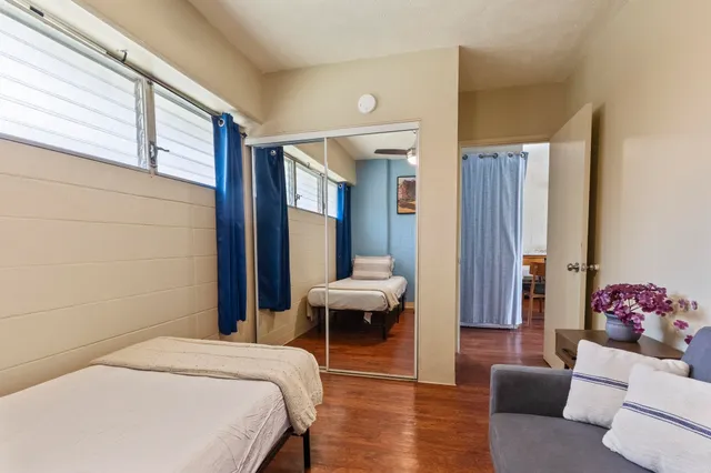 a spacious bedroom with a bed and a couch