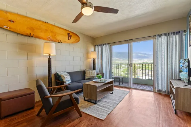a living room with furniture and a floor to ceiling window