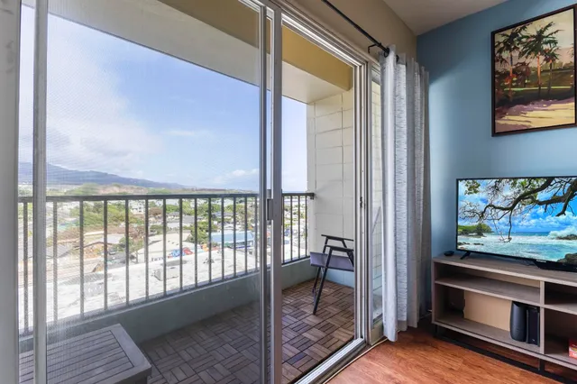 a view of a hallway with wooden floor and furniture