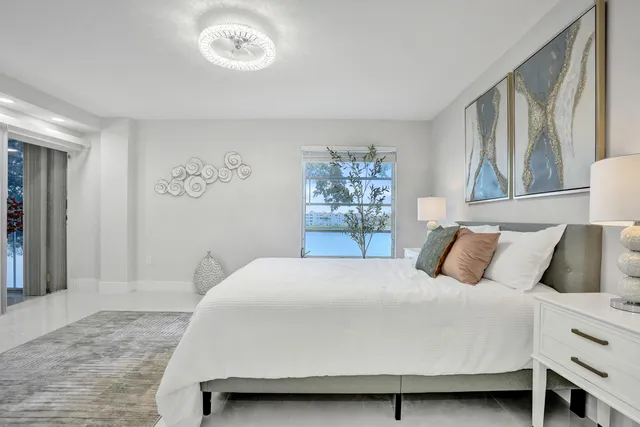 a spacious bedroom with a bed and a mirror