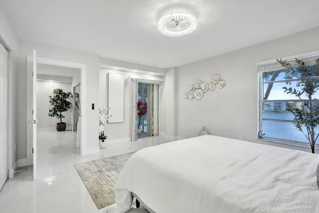 a bedroom with a large bed and a large mirror