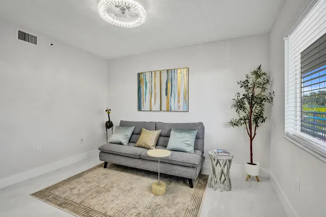 a living room with furniture and a glass door