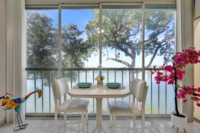 a front view of a house with a yard and potted plants