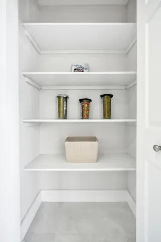a en suite bathroom with a granite countertop sink and a mirror