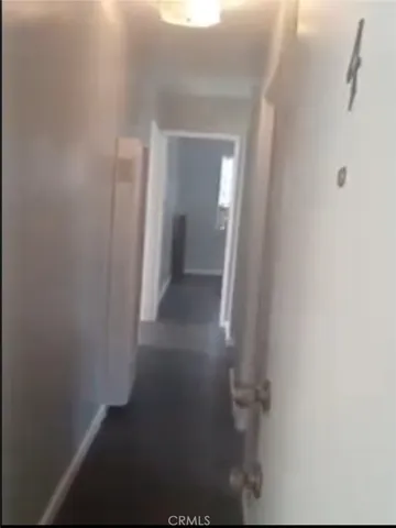 a view of a small space with wooden floor and a window