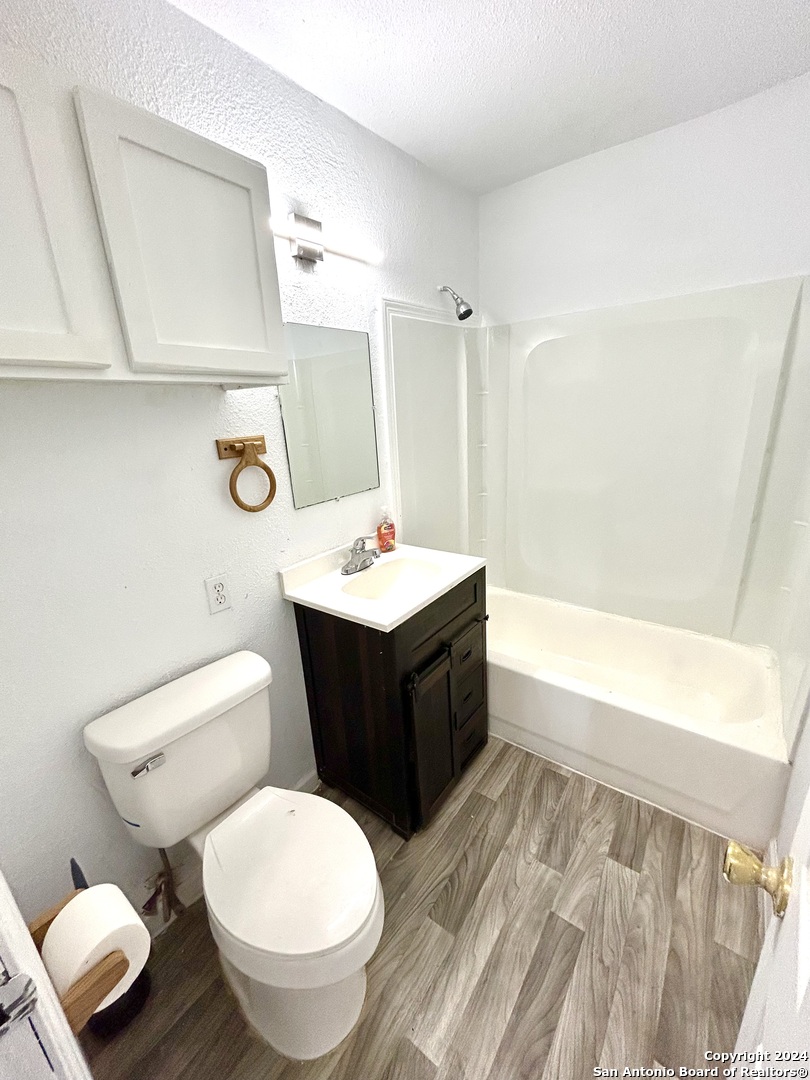 3539 Rivas Street San Antonio, TX 78228 - Photo 8 of 15 a bathroom with a bathtub sink mirror vanity and toilet