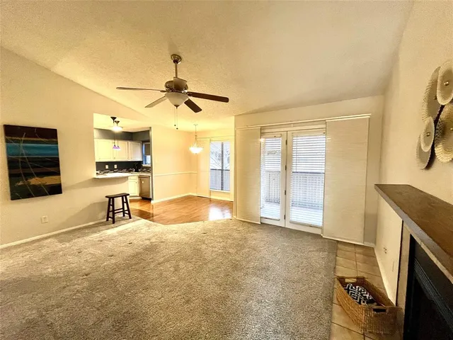 a view of a livingroom with a fireplace and a window