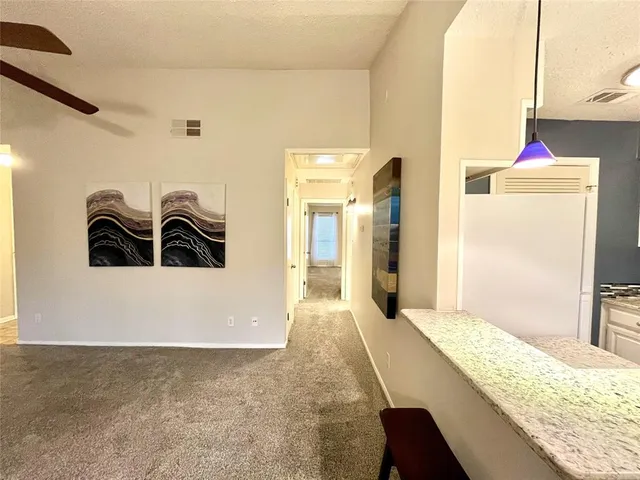 a hallway with a sink and cabinets