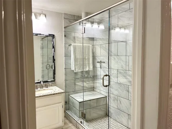 a bathroom with a shower and a sink