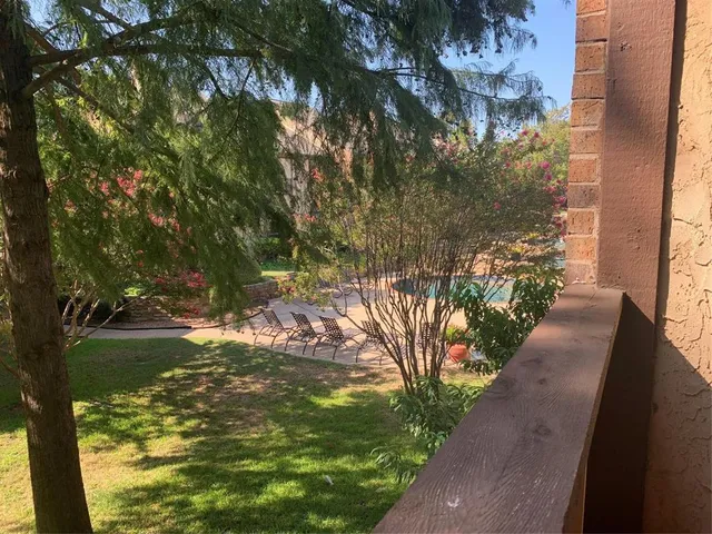 a view of a house with pool and chairs
