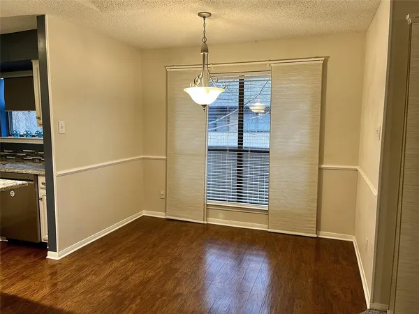 a view of a room with wooden floor and windows