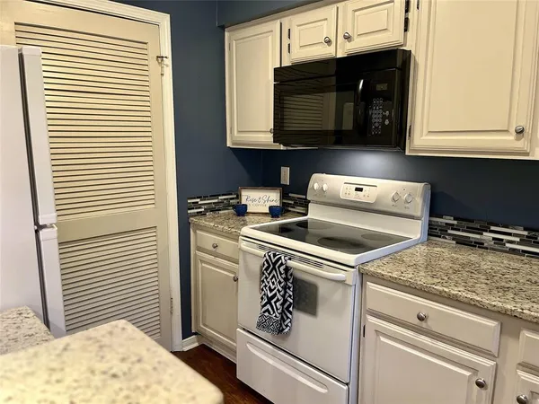 a kitchen with a stove and a microwave