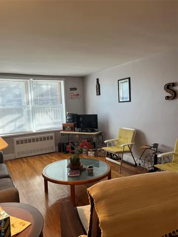 a living room with furniture and a large window