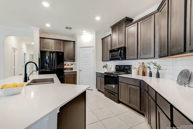 a kitchen with a sink and cabinets