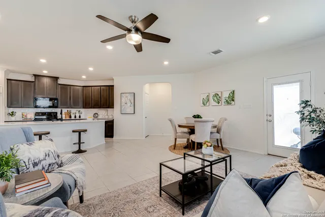 a living room with furniture a table and chairs