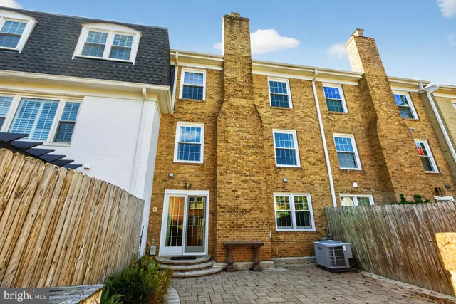 a view of a brick house with many windows