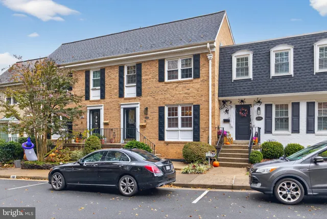 a car parked in front of a brick house