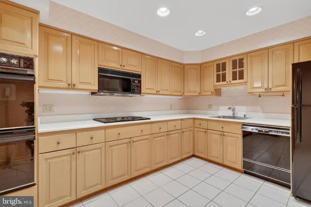 a kitchen with granite countertop cabinets stainless steel appliances and a sink