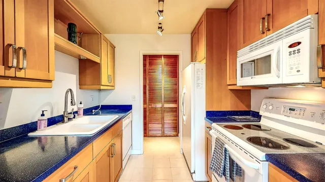 a kitchen with stainless steel appliances granite countertop a sink and cabinets