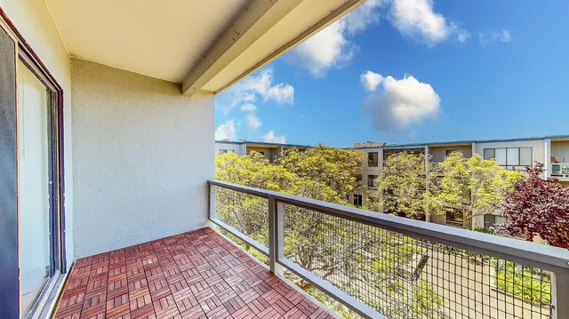 a front view of a building with a garden