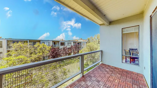 a wooden bench sitting in front of a building