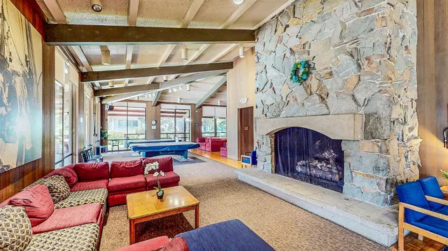 a view of a swimming pool with a yard and potted plants