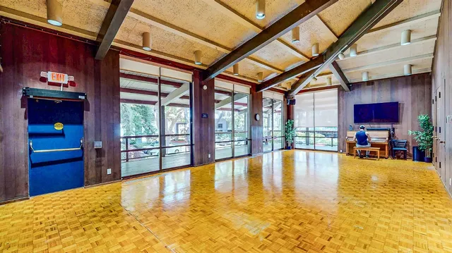 a view of a kitchen with kitchen island wooden floor and windows