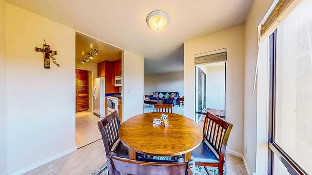 a dining room with furniture and window