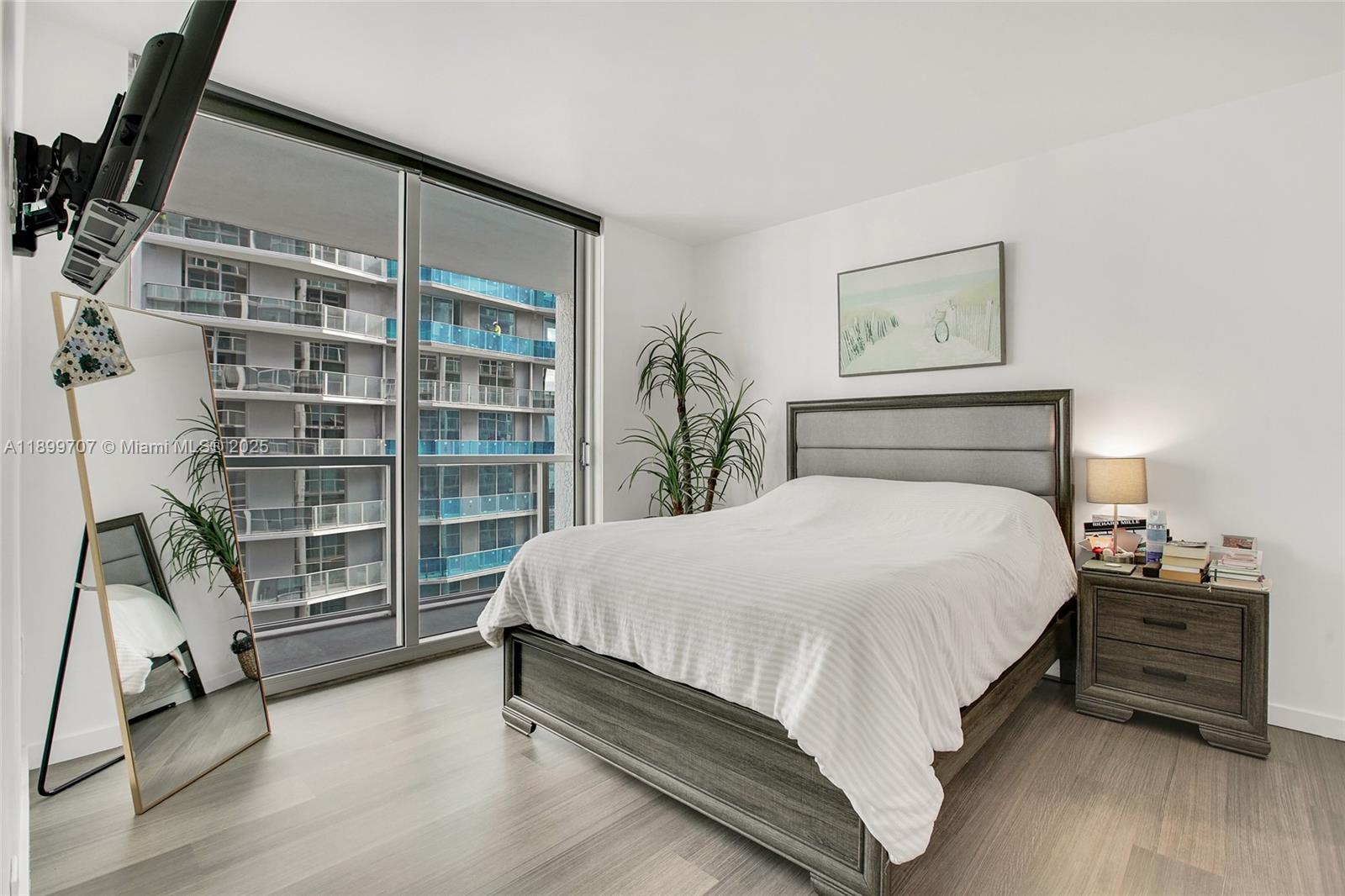 55 Southeast 6th Street, Unit 3701 Miami, FL 33131 - Photo 12 of 21 a large bed sitting in a bedroom next to a window