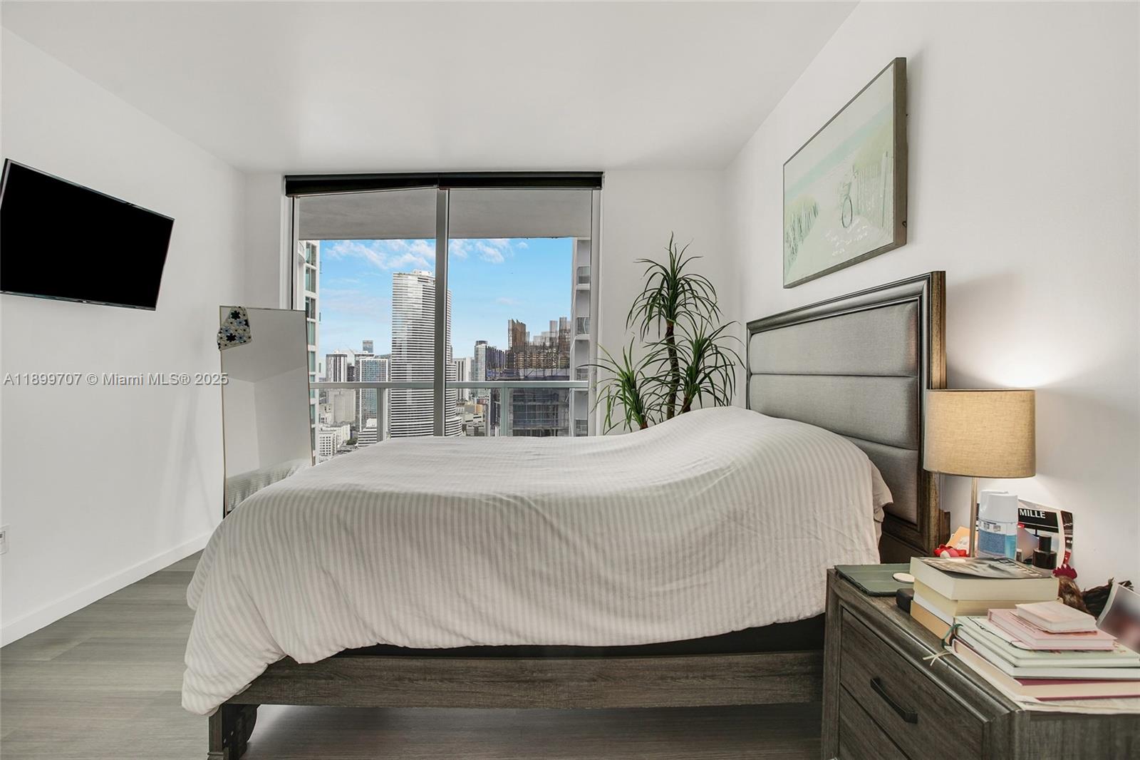 55 Southeast 6th Street, Unit 3701 Miami, FL 33131 - Photo 13 of 21 a bedroom with a bed window and flat screen tv