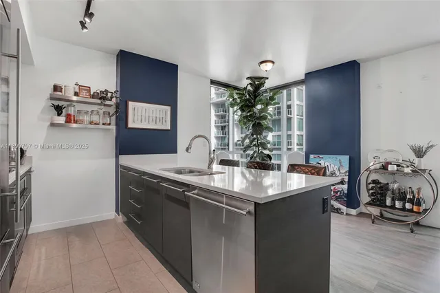 a kitchen with stainless steel appliances a sink and a refrigerator