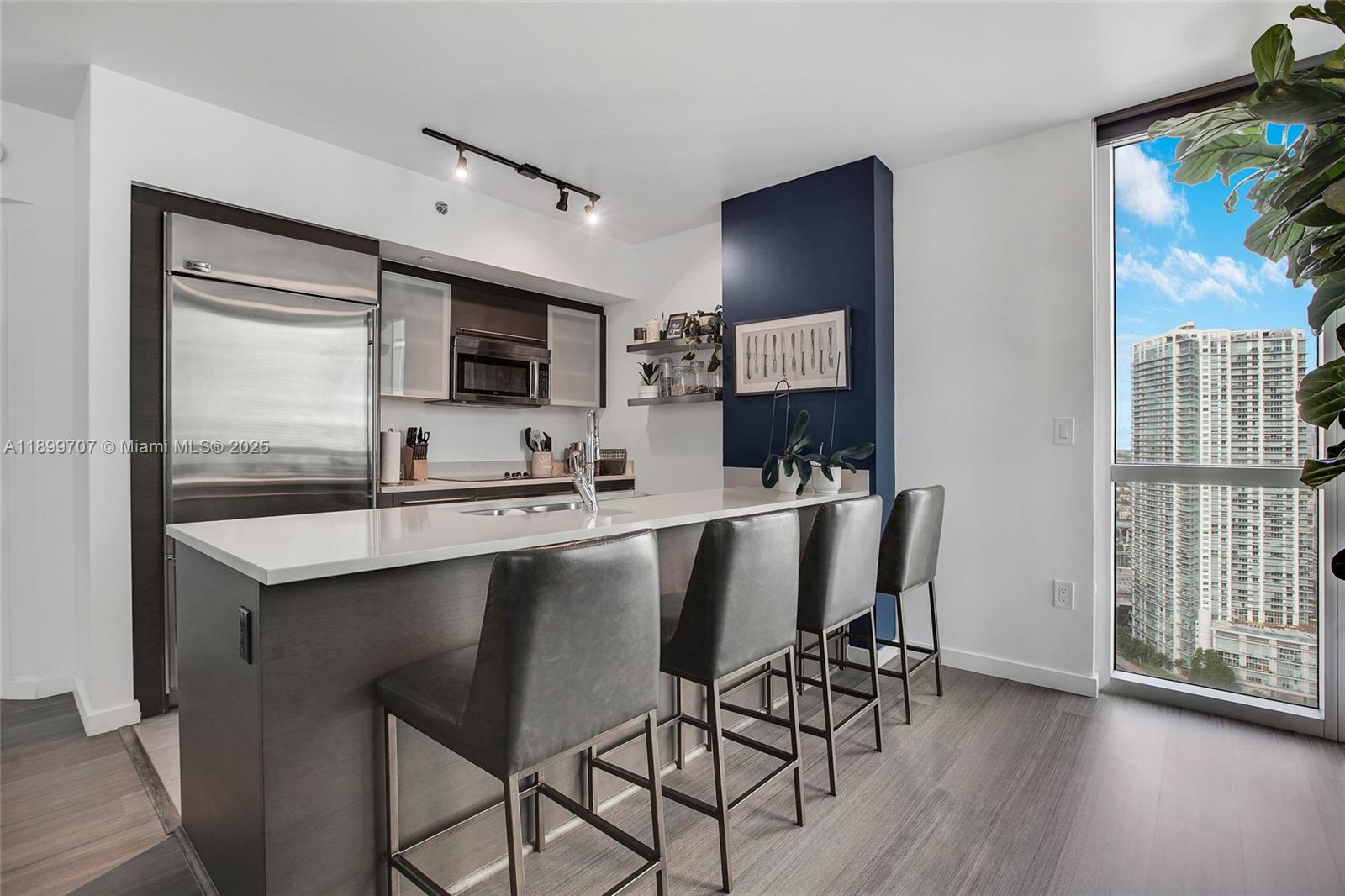 55 Southeast 6th Street, Unit 3701 Miami, FL 33131 - Photo 7 of 21 a dining room with furniture and wooden floor