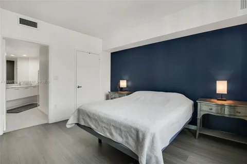 a bedroom with a bed and a lamp