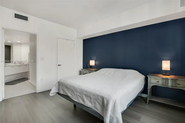 a bedroom with a bed and a lamp