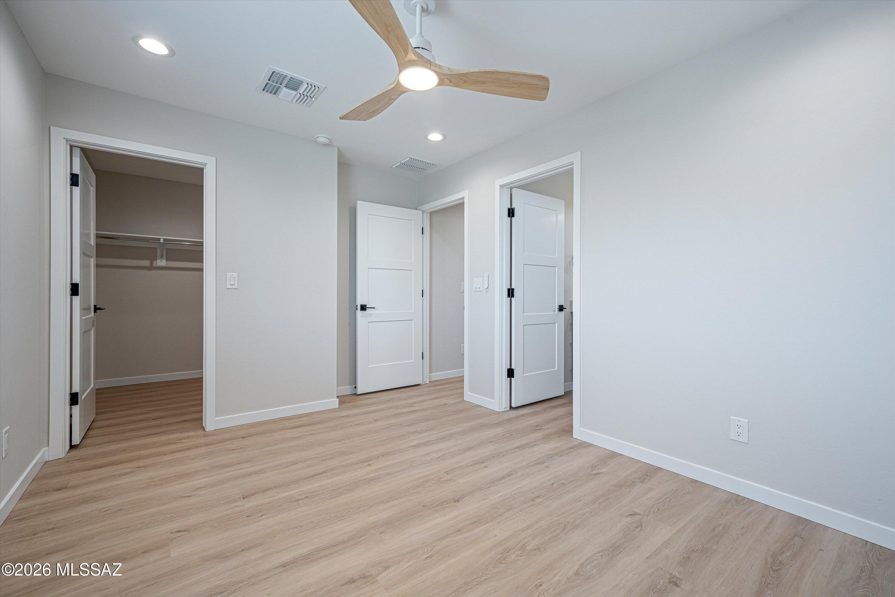739 North Queen Avenue, Unit 2 Tucson, AZ 85705 - Photo 7 of 28 wooden floor in an empty room with a window