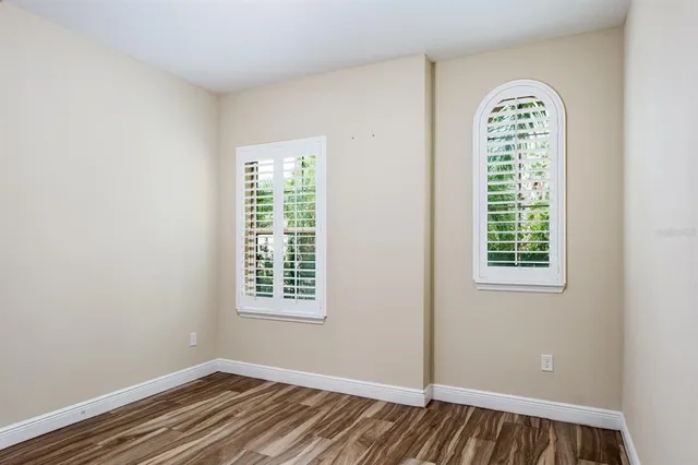 an empty room with windows and closet