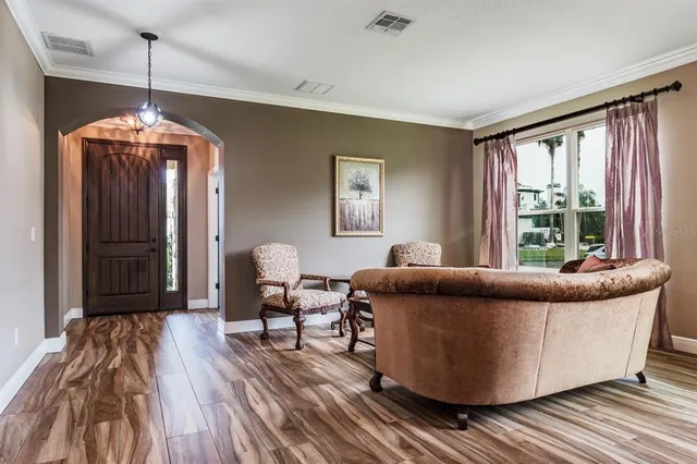 a view of a dining room with furniture and chandelier