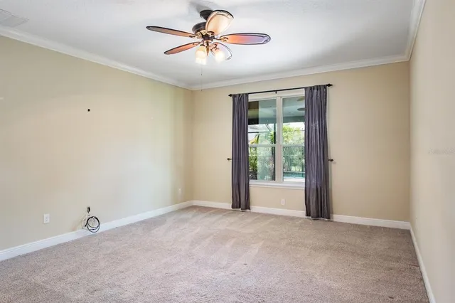 a dining room with furniture water view and a floor to ceiling window