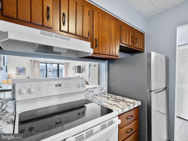 a kitchen with kitchen island a stove microwave and refrigerator