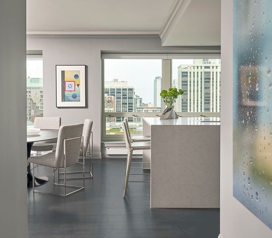 a dining room with furniture and a floor to ceiling window